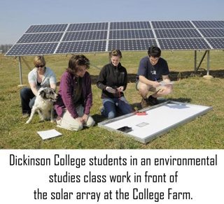 Students in an environmental-studies class work in front of the solar array at the College Farm.
